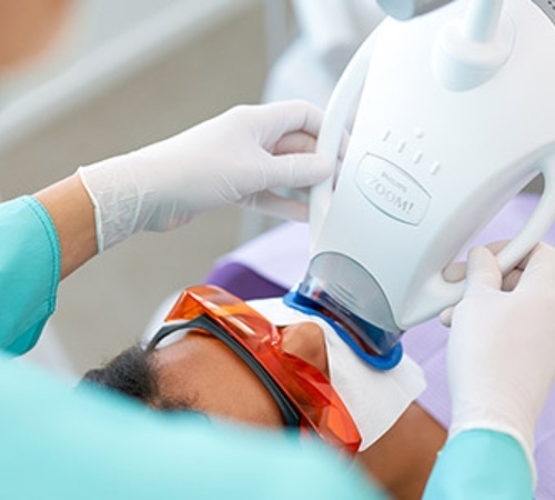 Man receiving in-office teeth whitening treatment