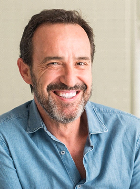 Closeup of senior man smiling with dentures