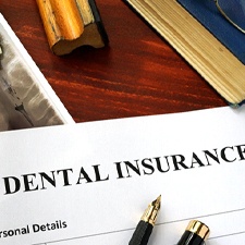 Dental insurance paperwork on wooden desk