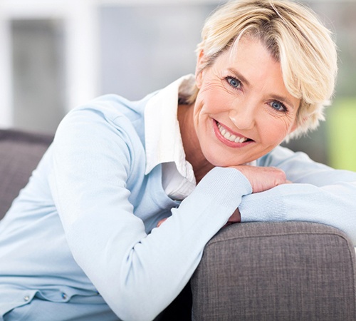 Woman uses proper dental implant care in Houston