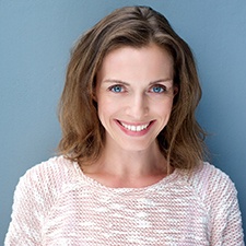 Woman smiles with dental implants in Houston
