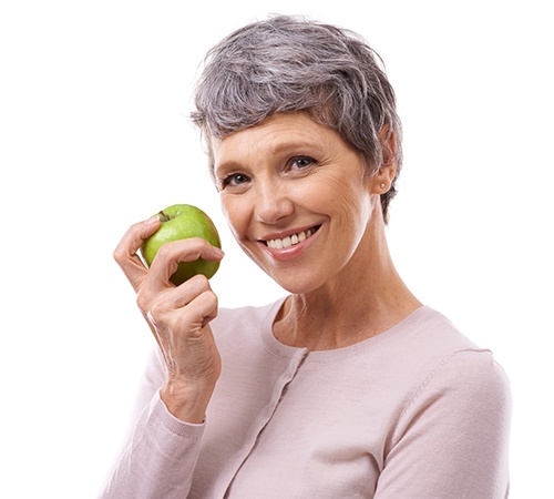 woman holding a green apple