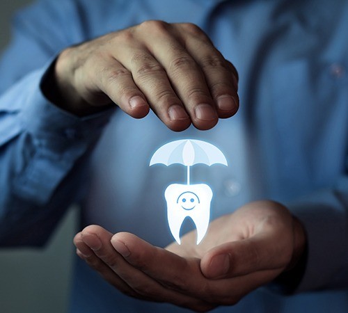 Hands holding an animated tooth under an umbrella