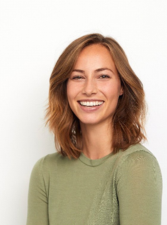 smiling woman with Invisalign in Houston